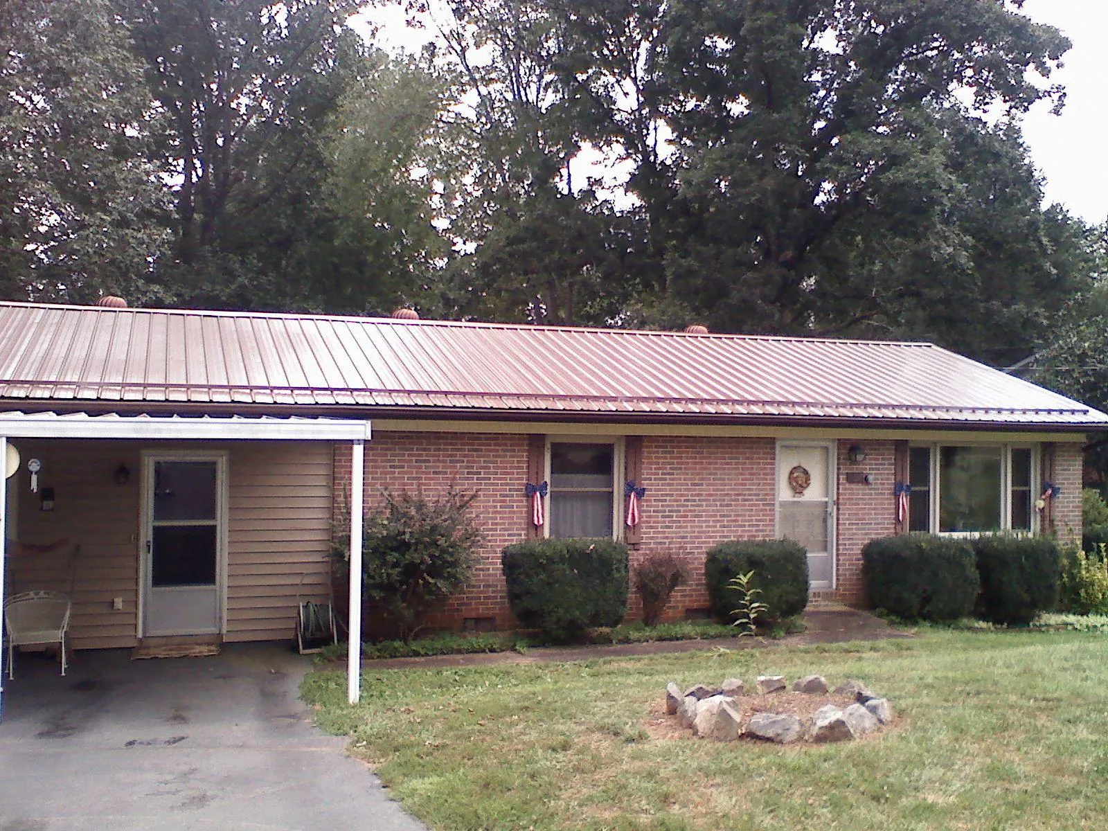 Bronze metal roof and carport on a brick ranch home — Roof Repair work by our crew in North Fairfield